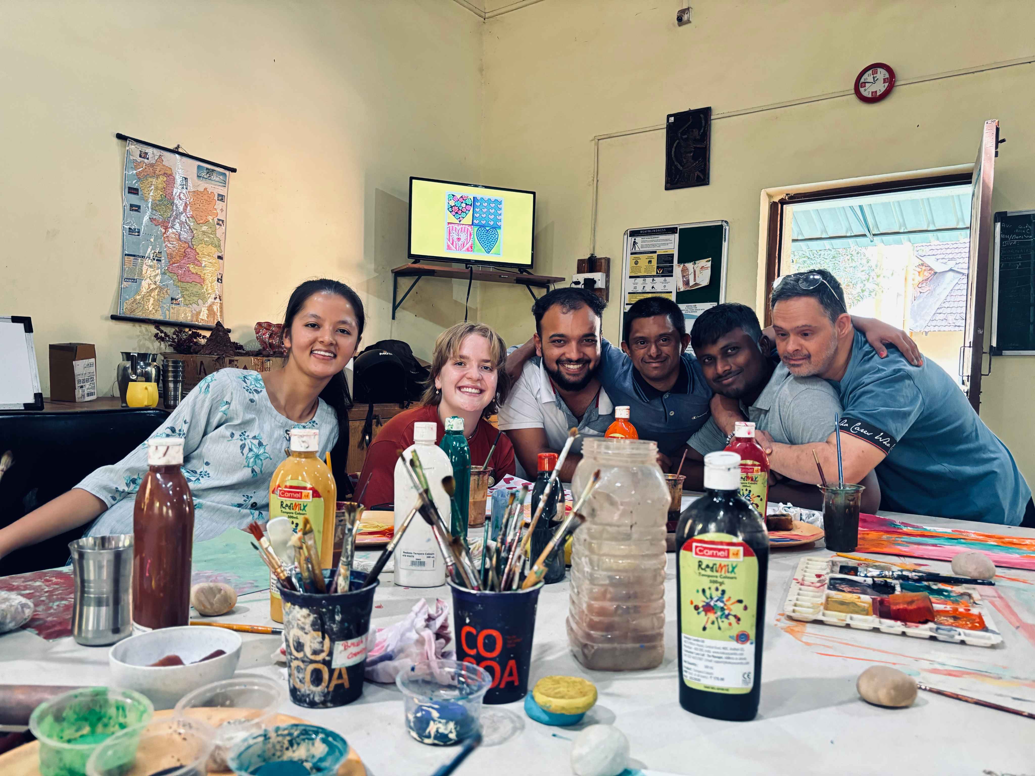 Volunteers and support staff at a group creative workshop